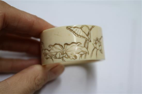 An ivory brise fan and an ivory Art Nouveau serviette ring